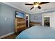 Bedroom with large dresser, ceiling fan, and laundry access at 1521 Siesta Dr, Sarasota, FL 34239