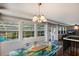 Bright dining room featuring a unique table and view to the backyard through large windows at 1521 Siesta Dr, Sarasota, FL 34239