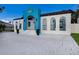 Home with a unique blue fish accent and brick driveway at 1521 Siesta Dr, Sarasota, FL 34239