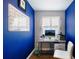 Bright home office with a desk, computer, and blue walls at 1521 Siesta Dr, Sarasota, FL 34239