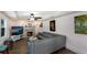 Spacious living room with fireplace, large sectional sofa, and hardwood floors at 1521 Siesta Dr, Sarasota, FL 34239