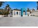 Bright white home with a unique blue fish accent and brick driveway at 1521 Siesta Dr, Sarasota, FL 34239