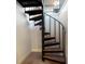 Modern spiral staircase with metal railing and wooden steps at 1521 Siesta Dr, Sarasota, FL 34239