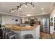 Modern kitchen boasts granite countertops, stainless steel appliances, and track lighting at 1521 Siesta Dr, Sarasota, FL 34239