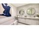 Modern bathroom with double vanity, large mirrors, and hexagon tile at 1591 Gulf Of Mexico Dr # 316, Longboat Key, FL 34228