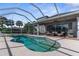 Enjoy the refreshing pool, screened patio, and outdoor kitchen at 1868 Scarlett Ave, North Port, FL 34289