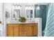 Bathroom featuring double sinks, a plant accent, and an enclosed shower with blue tile at 1868 Scarlett Ave, North Port, FL 34289