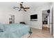 Bright bedroom with a ceiling fan, TV, and an open doorway leading to an adjacent area at 1868 Scarlett Ave, North Port, FL 34289