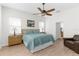 Serene bedroom featuring a ceiling fan, two windows, and a comfortable queen-size bed at 1868 Scarlett Ave, North Port, FL 34289