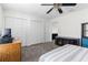 Bright bedroom with carpeted floors, a ceiling fan, and multiple closets for ample storage space at 1868 Scarlett Ave, North Port, FL 34289