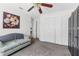 Bedroom with a large closet, neutral carpet, a light green sofa, ceiling fan and flower print at 1868 Scarlett Ave, North Port, FL 34289