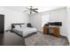 Neutral bedroom showcasing a ceiling fan, carpeted floors, and a dedicated workspace with a wooden desk at 1868 Scarlett Ave, North Port, FL 34289