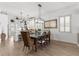 Cozy dining room with a wooden table, chairs, and a view of the kitchen at 1868 Scarlett Ave, North Port, FL 34289