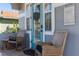 Inviting front porch with rocking chairs, a turquoise door, and charming decor, creating a relaxing outdoor space at 1868 Scarlett Ave, North Port, FL 34289