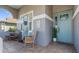 Welcoming front porch with rocking chairs and a beautiful turquoise door, creating a cozy and inviting entrance at 1868 Scarlett Ave, North Port, FL 34289