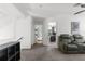 Upstairs hallway with carpet, leading to bedroom, bathroom, and Gathering area with gray reclining sofa at 1868 Scarlett Ave, North Port, FL 34289