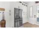 Kitchen featuring stainless steel refrigerator and white cabinetry, offering ample storage and a sleek, modern design at 1868 Scarlett Ave, North Port, FL 34289