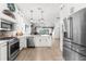 Bright kitchen featuring stainless steel appliances, an island, and wood flooring at 1868 Scarlett Ave, North Port, FL 34289