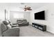 Comfortable living room with plush reclining seating, perfect for relaxing and watching TV at 1868 Scarlett Ave, North Port, FL 34289