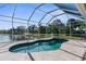 Beautiful pool area featuring a screened enclosure and a scenic lake view at 1868 Scarlett Ave, North Port, FL 34289
