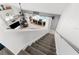 Staircase leading down to living area with a fire place, large tv and sliding glass doors to the pool at 1868 Scarlett Ave, North Port, FL 34289