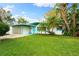 Mid-century modern home with a landscaped lawn at 2225 Valencia Dr, Sarasota, FL 34239