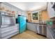 Retro kitchen with teal refrigerator and stainless steel appliances at 2225 Valencia Dr, Sarasota, FL 34239