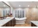 Elegant bathroom with a freestanding tub and granite countertops at 2364 Floyd St, Sarasota, FL 34239