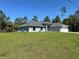 Single-story home boasts a spacious lawn, well maintained landscaping and a large driveway at 3006 Chickasaw Ave, North Port, FL 34288