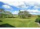 Landscaped backyard with a view of a golf course at 381 Bobby Jones Rd # 381, Sarasota, FL 34232