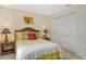 Cozy bedroom with a queen bed, wicker headboard, and ample closet space at 381 Bobby Jones Rd # 381, Sarasota, FL 34232