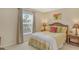 Bright bedroom with a queen bed, wicker headboard, and two nightstands at 381 Bobby Jones Rd # 381, Sarasota, FL 34232