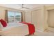 Bright bedroom with a queen bed, ceiling fan, and large closet at 381 Bobby Jones Rd # 381, Sarasota, FL 34232