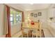 Dining area featuring a wood table, chairs, and window with drapes at 381 Bobby Jones Rd # 381, Sarasota, FL 34232
