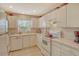 Clean kitchen featuring white cabinets, countertops, and appliances at 381 Bobby Jones Rd # 381, Sarasota, FL 34232