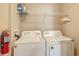 Laundry room with washer, dryer and shelving at 4134 Central Sarasota Pkwy # 1734, Sarasota, FL 34238