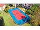 Community tennis court with red clay surface and blue border at 4134 Central Sarasota Pkwy # 1734, Sarasota, FL 34238
