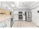 Modern kitchen with stainless steel appliances and white cabinetry at 4156 Bowling Green Cir # 28, Sarasota, FL 34233