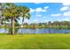 Backyard with pond view and lush green grass at 4156 Bowling Green Cir # 28, Sarasota, FL 34233