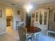 Dining room with wood table, china cabinet, and kitchen view at 449 Botticelli Dr # 449, Nokomis, FL 34275