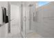 Walk-in shower with grey tile, glass enclosure, and pebble floor at 4726 Rivetta Ct, Sarasota, FL 34231