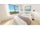 Bright bedroom with a queen-size bed and large window offering a treetop view at 4950 Remington Dr # 108, Sarasota, FL 34234