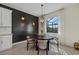 Modern dining area with dark wood table and statement wall at 5054 Seafoam Trl, Bradenton, FL 34211