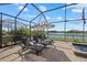 Relaxing patio area with lounge chairs and lake view at 5054 Seafoam Trl, Bradenton, FL 34211