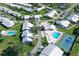 An aerial view of Crestwood Villas featuring community pools, tennis court, lush landscaping, and well-maintained homes at 5395 Christie Ann Pl # 9, Sarasota, FL 34233