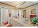 Bright bathroom featuring a dual sink vanity, large mirror, and storage at 5395 Christie Ann Pl # 9, Sarasota, FL 34233