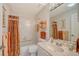 Well-lit bathroom with a tiled shower/tub combination, single vanity, toilet, and neutral color scheme at 5395 Christie Ann Pl # 9, Sarasota, FL 34233