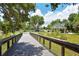 Community bridge offering beautiful green scenery, leading to recreation area at 5395 Christie Ann Pl # 9, Sarasota, FL 34233