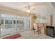 The den has tile floors, large sliding glass doors to the lanai, and a ceiling fan at 5395 Christie Ann Pl # 9, Sarasota, FL 34233