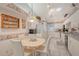 A cozy dining area with a round table, four chairs, and decoratively trimmed walls at 5395 Christie Ann Pl # 9, Sarasota, FL 34233